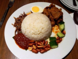 a plate of rice complete with side dishes and chili sauce Deva Devi Beach Inn
