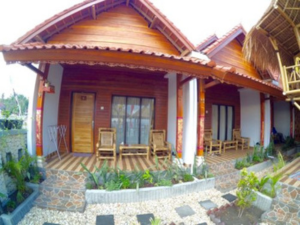 wooden house with front garden Coastal Inn